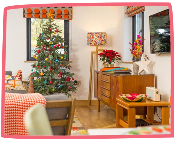 Living room in a cottage at Bosinver decorated for Christmas.