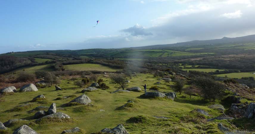 Adult flying a kite at Helman Tor Nature Reserve