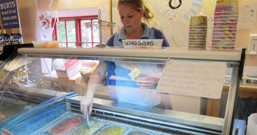 Lady serving ice cream at Roskilly's Ice Cream parlour in Cornwall.