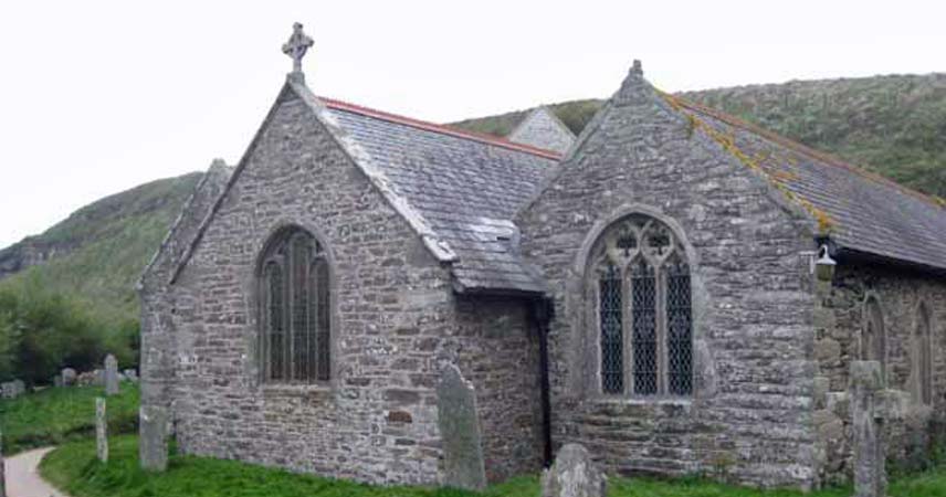 Picture of Gunwallow Church in Cornwall, showcasing it's windows and the graveyard outside of it.