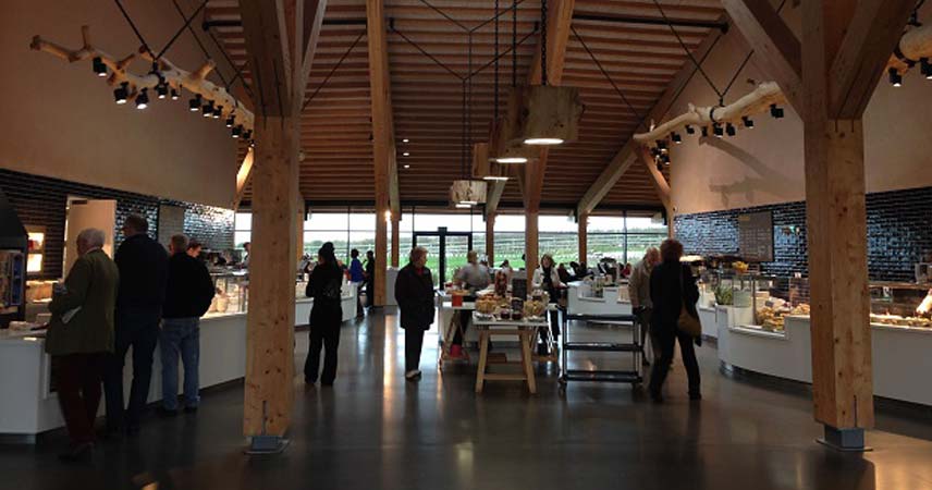 Picture of Gloucester Services, filled with people eating food from the canteen.