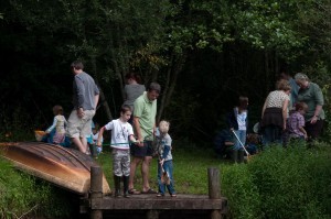 3 groups of families with young children exploring fields on the Bosinver site in Cornwall
