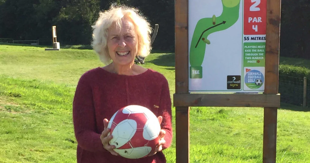 Action Nan Pat from Bosinver holding a football on a sunny day.