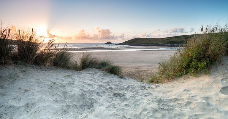 Sunset through the sand dunes at Crantock beach near Newquay in Cornwall