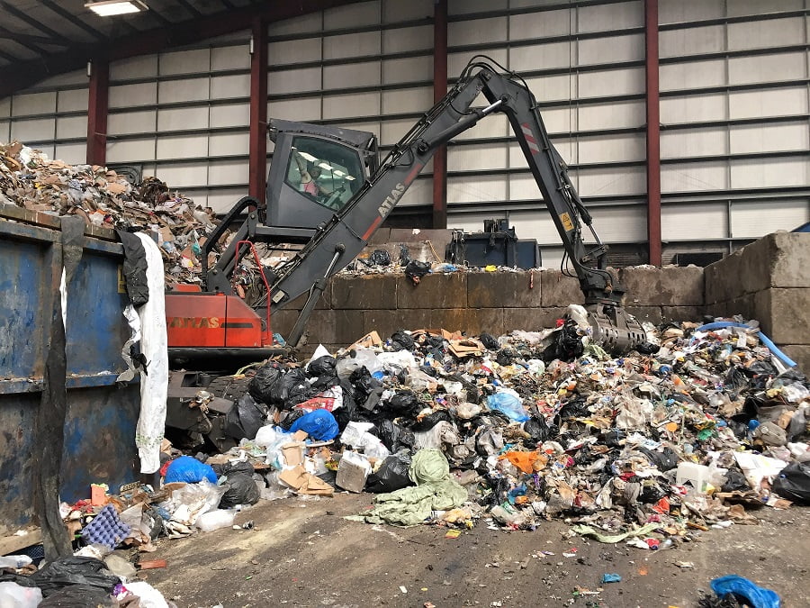 Machinery sorting waste and recycling in a facility.