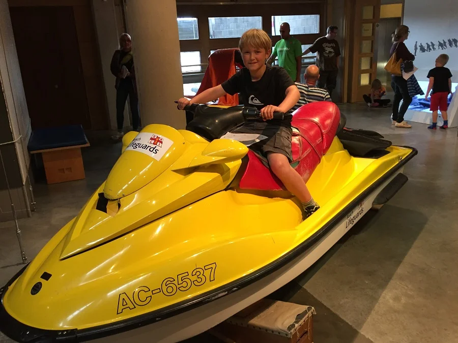 Young boy posing on a jetski at the National Maritime Museum in Cornwall.