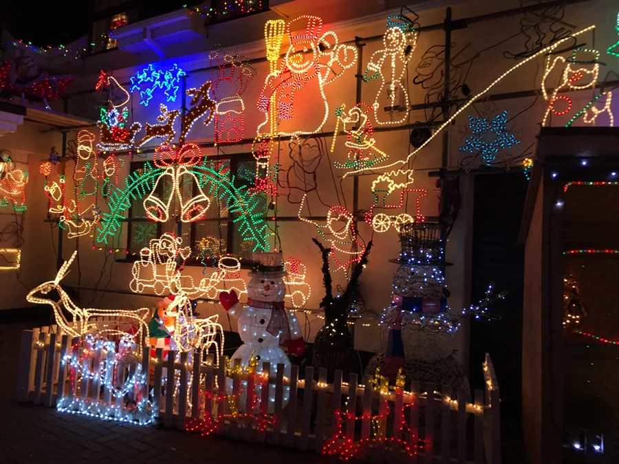 Outside of a building covered in illuminated Christmas decorations