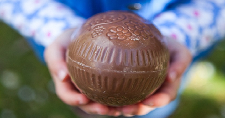 Close up shot of a chocolate easter egg in a persons hands