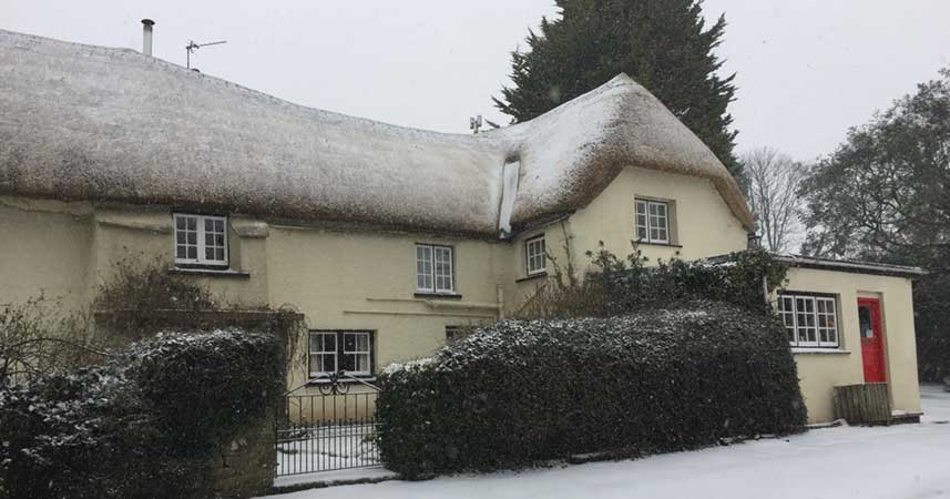 The Farmhouse cottage covered in snow at Bosinver in Cornwall