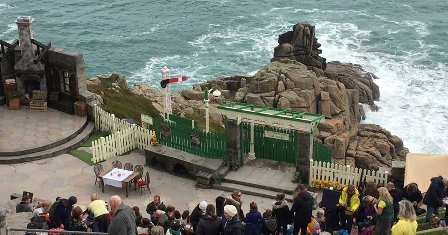 Minack outdoor theatre on the rocks with a large audience