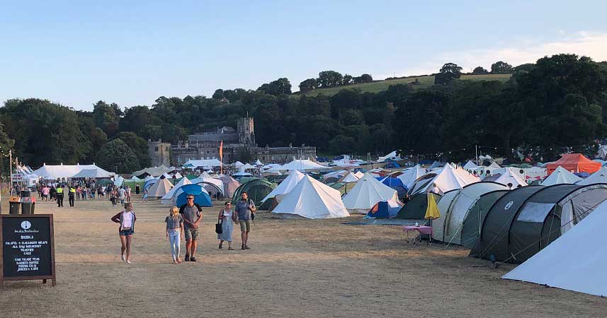 Landscape shot of large group of tents and campers in front of Port Eliot House