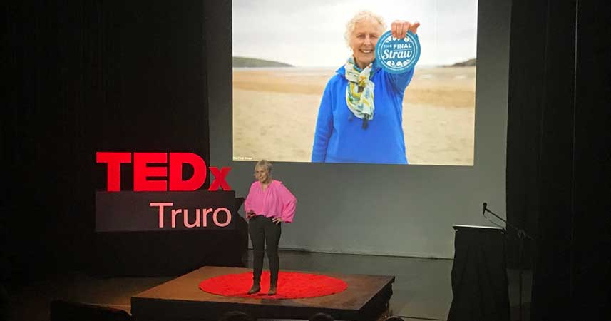 Nanny Pat stood on the TED x Truro stage with image of herself holding the Final Straw logo projected behind her.