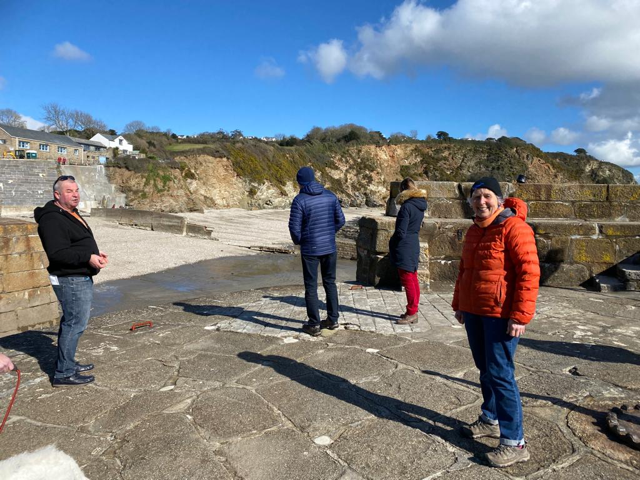 Lyndon shows the group the beach at Charlestown