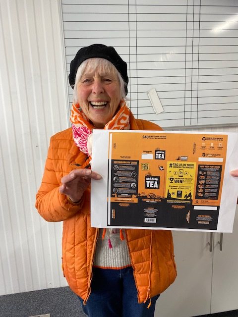 Pat Smith aka Action Nan holding the Cornish tea packagins which features her Action Nan campaign work