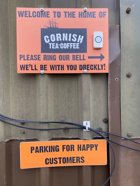 Cornish Tea sign, saying the team will be with you Dreckly and Parking for Happy Customers sign