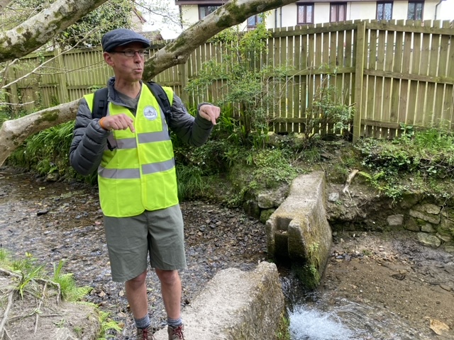Andy Trudgeon of Charlestown History Group giving a talk at a small waterfall in the 7 mile leat which was built to generate water flow for the harbour