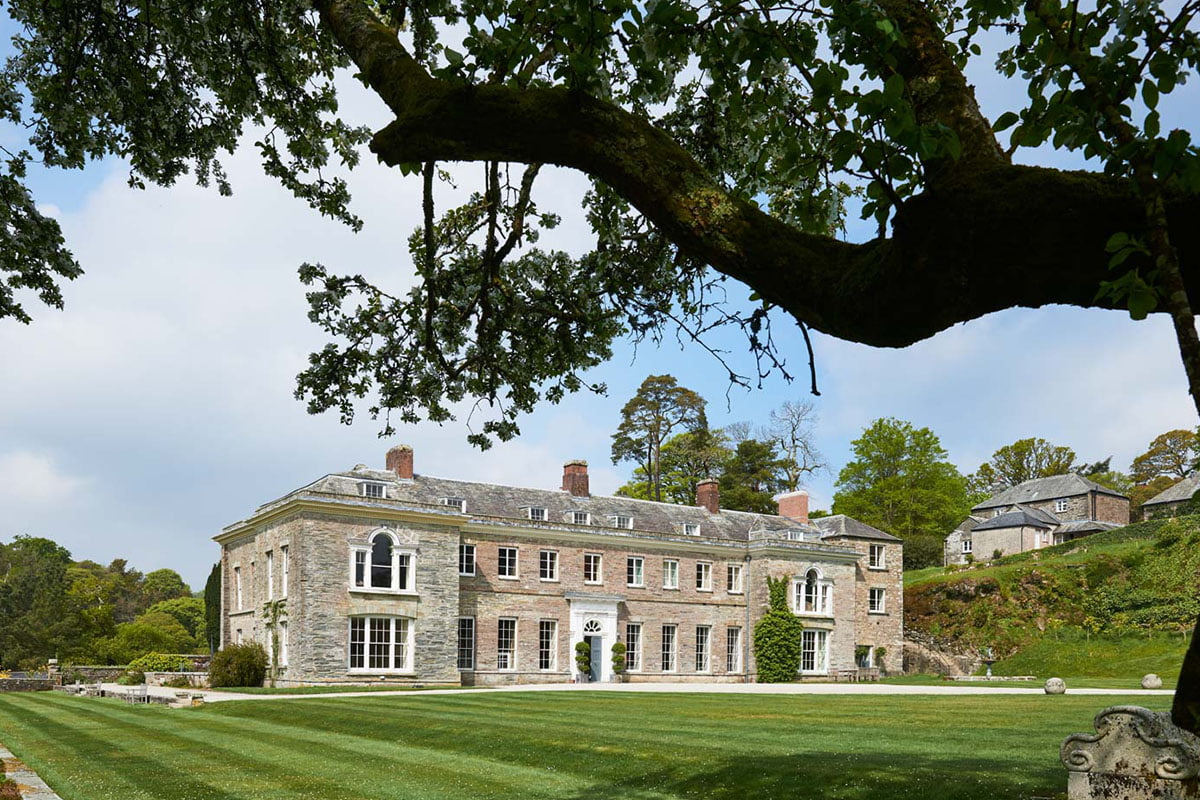 Wide shot of Boconnoc House in Cornwall, with its manicured lawn in full view.