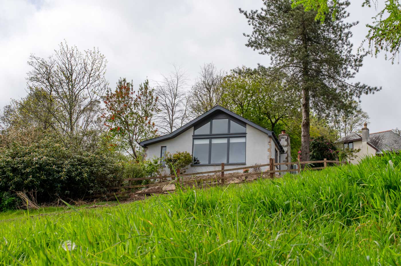Front shot of Hillside cottage at Bosinver in the trees.
