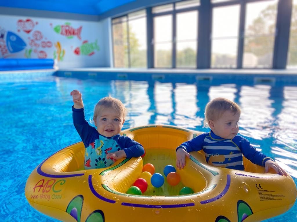 Two babies in a inflatable pool playing in Bosinver's swimming pool