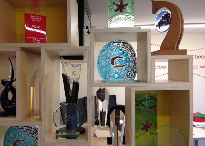 Tourism awards placed on a white abstract shelving unit