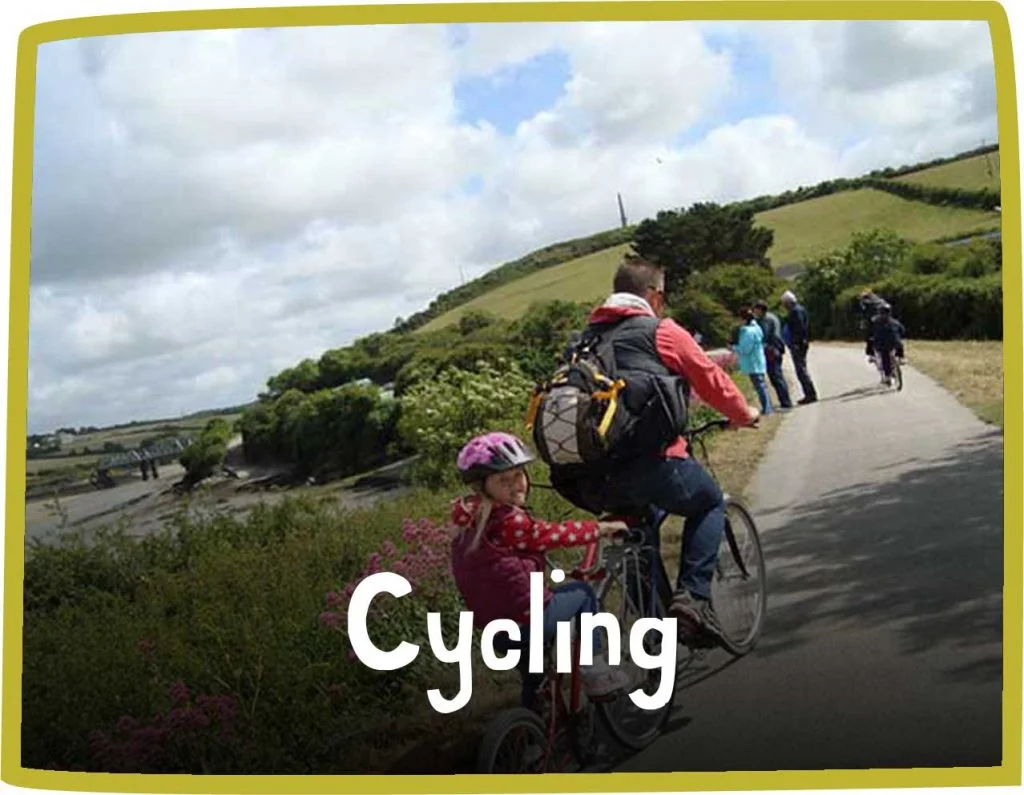 Green framed image of a man and a young girl on a tandem bike riding along a cycle path