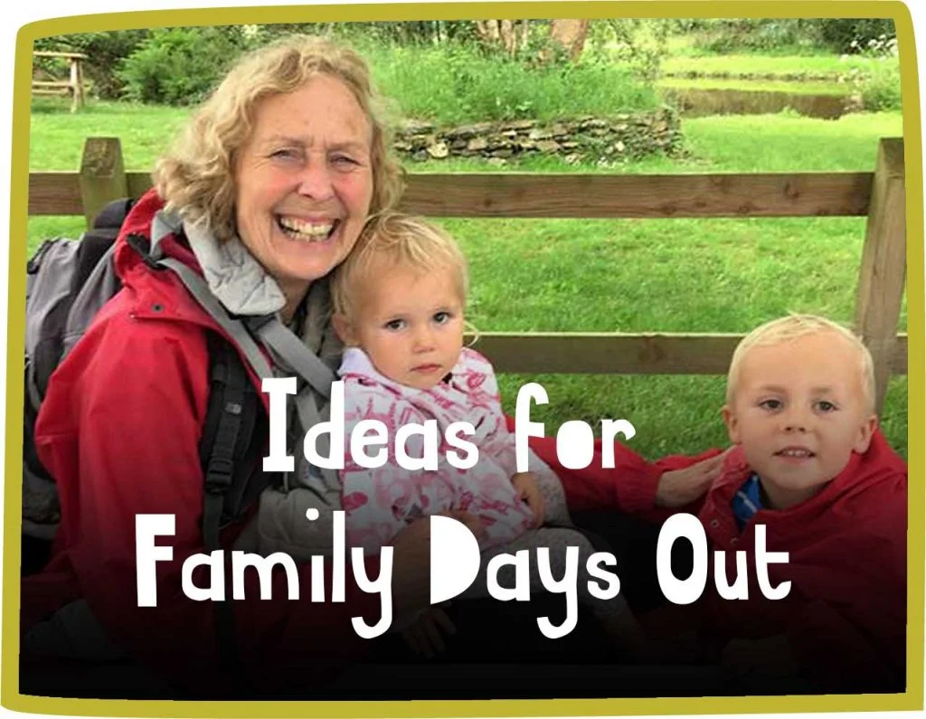 Green framed image of a smiling woman and two young kids sitting by a fence