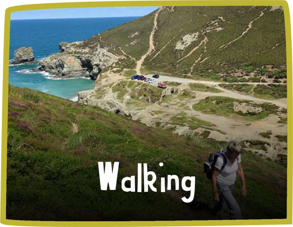 Green framed image of a woman hiking the South West Coast Path
