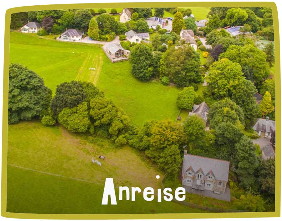 Aerial photo of Bosinver, showcasing the green fields, treeline and cottages