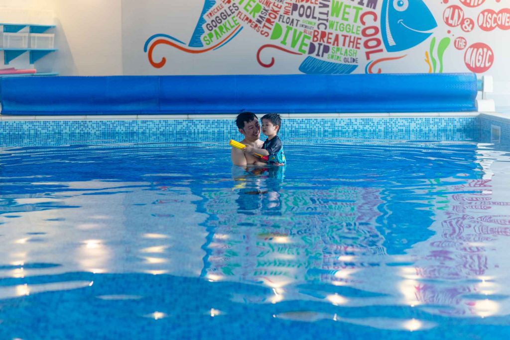 Father and son playing in the swimming pool at Bosinver.