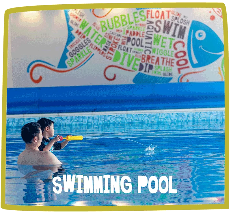 Father and son playing with a water gun with a swimming pool at Bosinver.