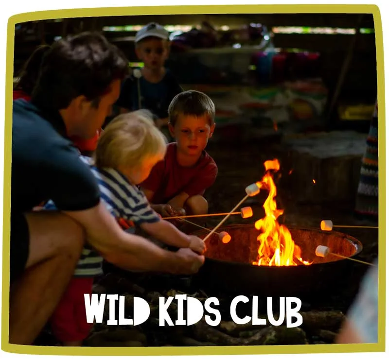Two children toasting marshmallows at Bosinver over an open fire