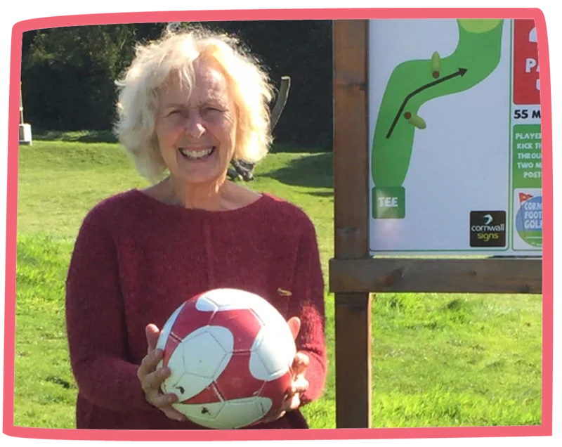 Action Nan Pat from Bosinver holding a football on a sunny day.