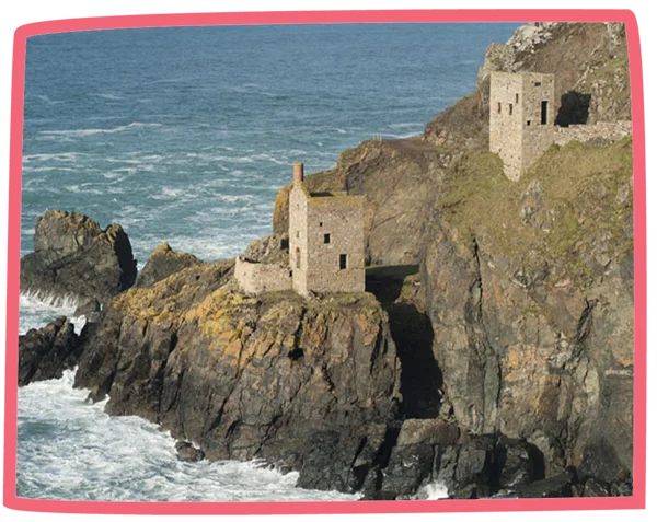 View of buildings situated across the Cornwall coast, close to the sea.