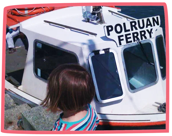 Close up of the Polruan Ferrywith a child in the foreground.