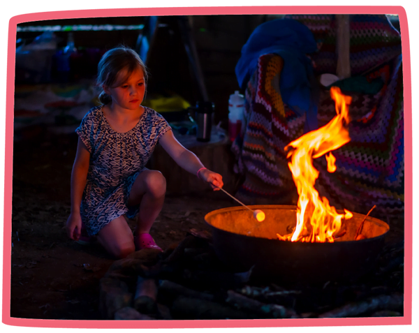 Child toasting marshmallows in the evening at Bosinver