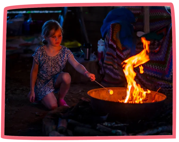 Child toasting marshmallows in the evening at Bosinver