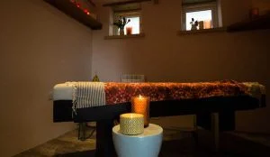 Massage table at Bosinver with two candles lit in the background.
