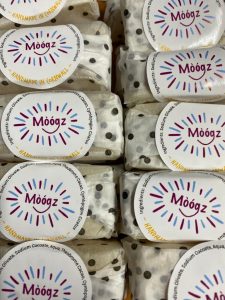 close up photo of handmade soaps wrapped in tissue paper and labelled with logo. 