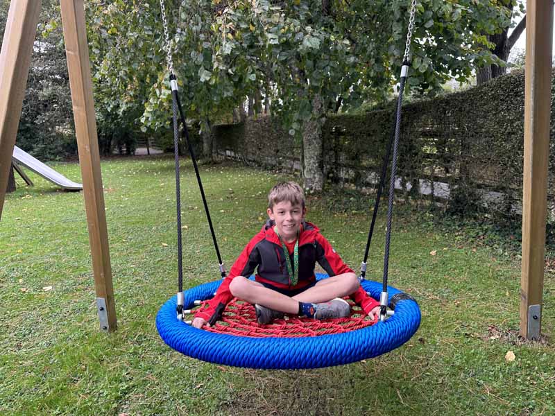 boy say on nest swing – a great place for those with autism or sensory issues to reset